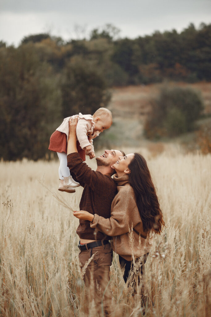 Cute and stylish family playing in a autumn field